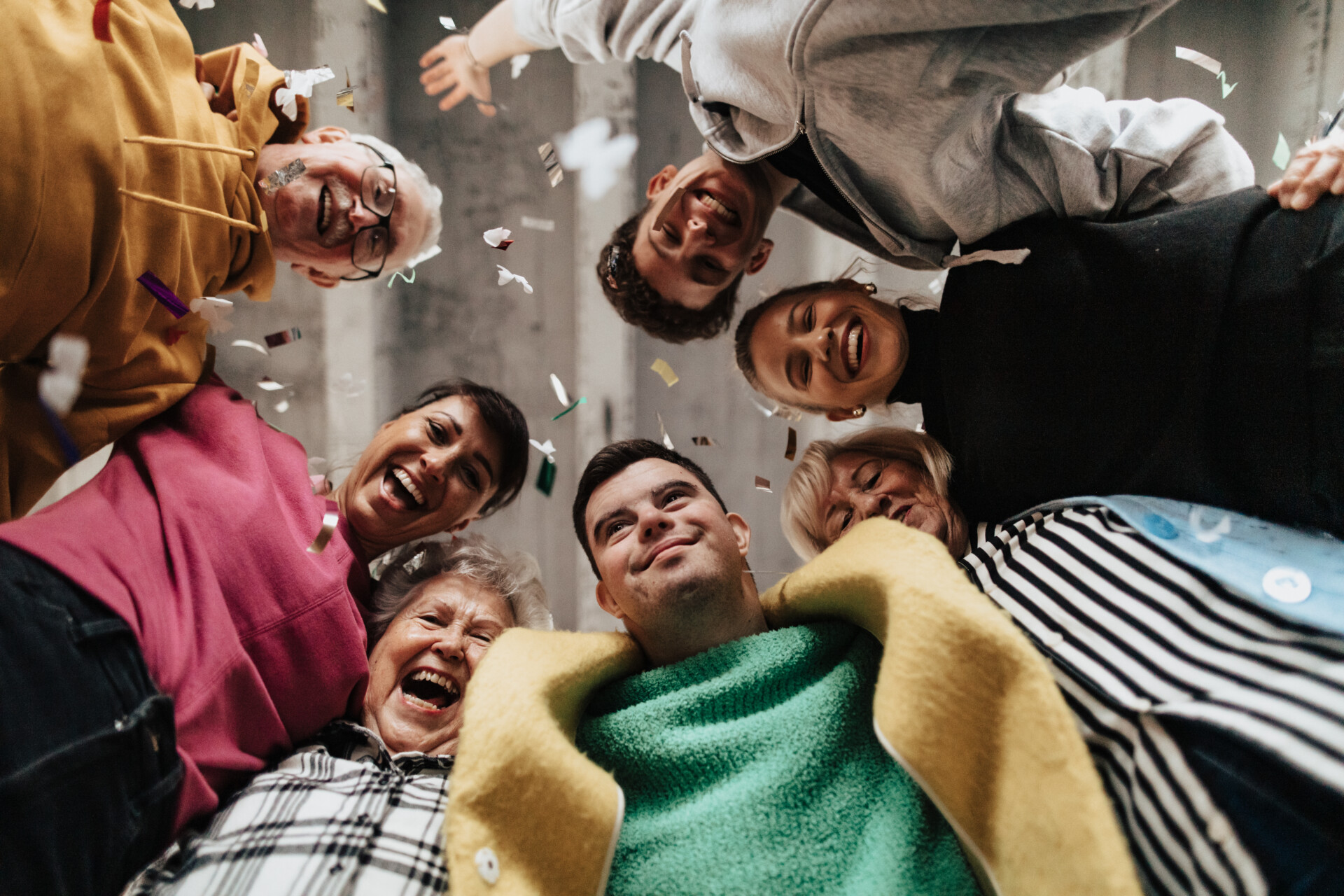 Low angle view of happy diverse models, looking at camera.